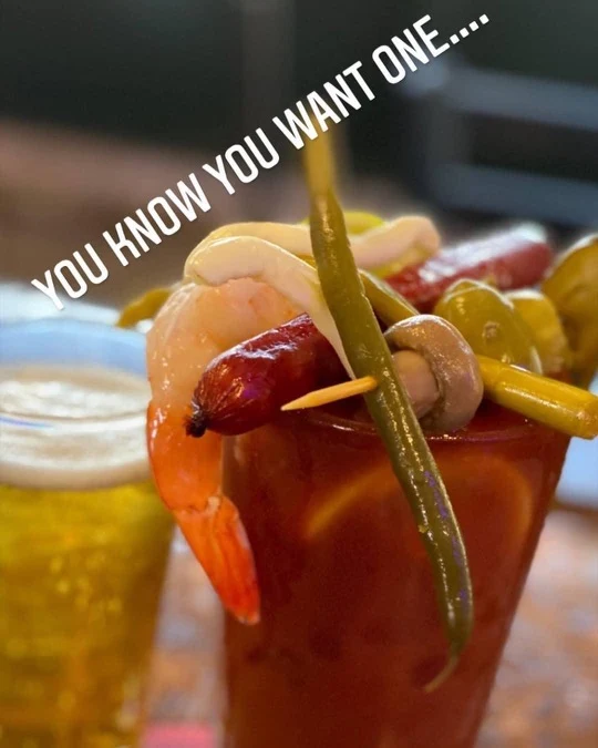 Loaded Bloody Mary at The Destination garnished with shrimp, sausage, green beans, olives and mushroom
