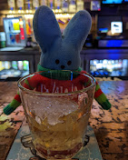 Cocktail on the bar garnished with one of the bar's plush Peeps bunny mascots